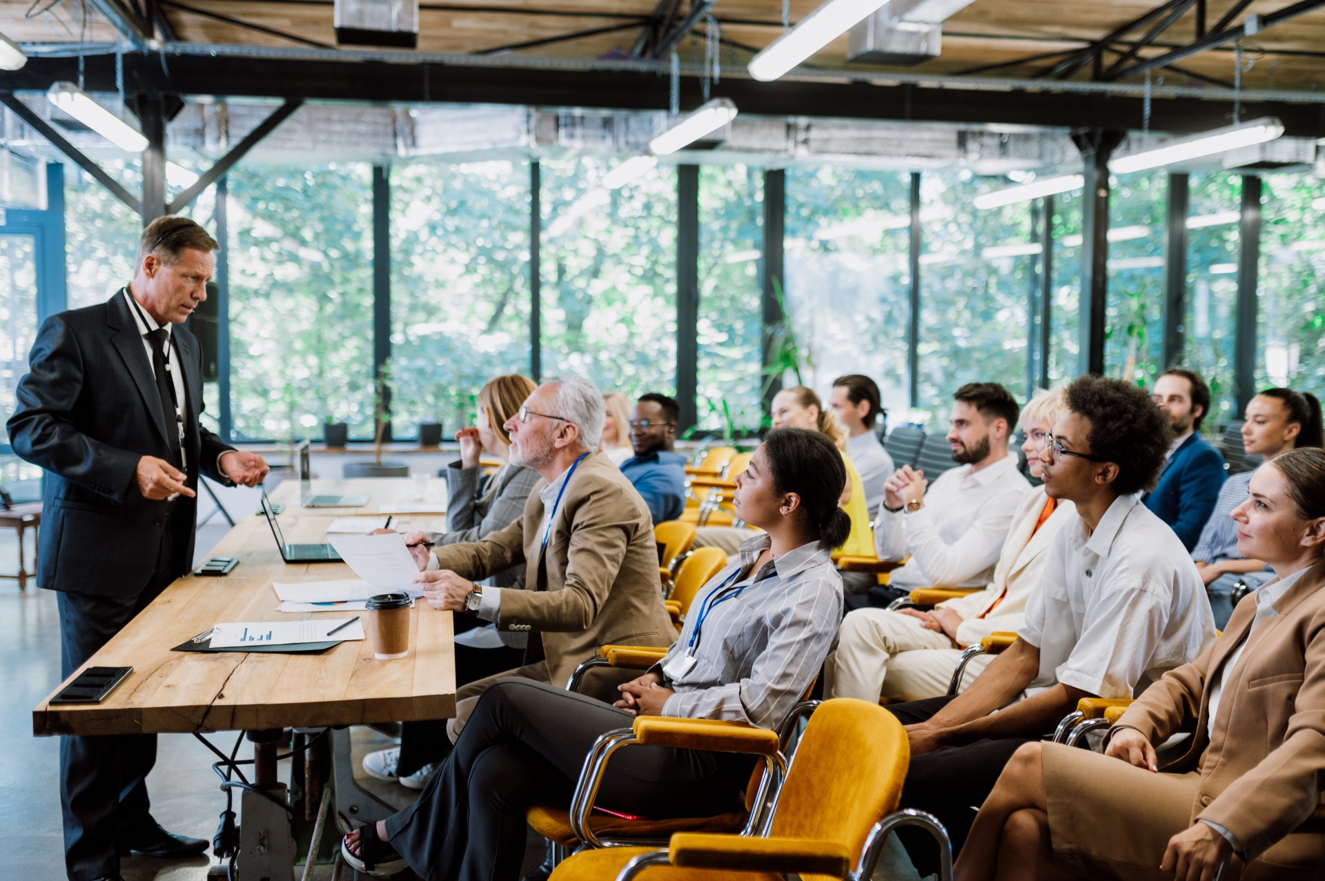 Cinematic image of a conference meeting. Business people sitting in a room listening to the motivator coach. Representation of a Self growth and improvement special event